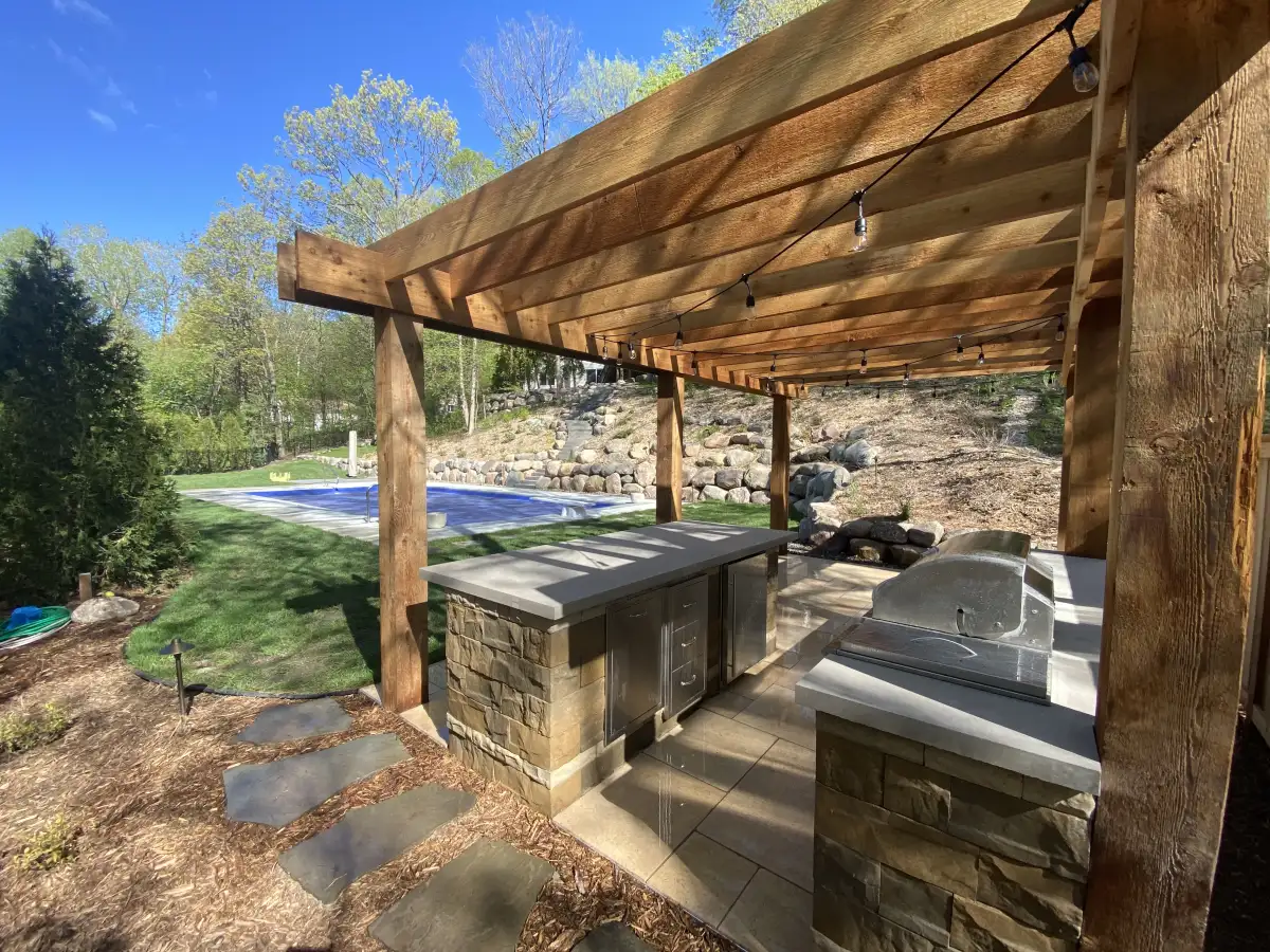 Wood pergola over a spa and paved seating area